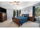 The primary bedroom is spacious with dual nightstands, a ceiling fan and soft blue paint at 12051 E Lake Cir, Greenwood Village, CO 80111