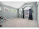 Bright bedroom featuring an arched window, three smaller windows and light gray walls at 12051 E Lake Cir, Greenwood Village, CO 80111