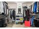 Walk in closet that is organized with plenty of space and a small window for natural light at 12051 E Lake Cir, Greenwood Village, CO 80111
