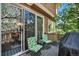 Relaxing deck with chairs and gas BBQ, leading indoors through sliding glass doors at 12051 E Lake Cir, Greenwood Village, CO 80111