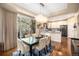 Elegant dining area with modern chandelier, hardwood floors and a large sliding glass door to the outdoor at 12051 E Lake Cir, Greenwood Village, CO 80111