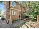 Exterior view of a backyard deck with BBQ, lawn, and home at 12051 E Lake Cir, Greenwood Village, CO 80111