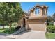 Attractive home with manicured front yard featuring an attached two-car garage, mature tree and covered front entrance at 12051 E Lake Cir, Greenwood Village, CO 80111