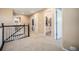 Hallway upstairs with views of the stairs and a bathroom; neutral carpet at 12051 E Lake Cir, Greenwood Village, CO 80111