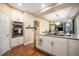 Open kitchen features a central island, stainless steel double ovens, and convenient access to the living and dining areas at 12051 E Lake Cir, Greenwood Village, CO 80111
