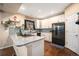 Modern kitchen with white cabinets, stainless steel appliances, granite countertops, and ample counter space at 12051 E Lake Cir, Greenwood Village, CO 80111