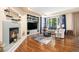 Bright living room with a cozy fireplace, custom built-ins and plush seating area, perfect for Gathering gatherings at 12051 E Lake Cir, Greenwood Village, CO 80111