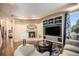 Inviting living room with a built-in entertainment center, a warm fireplace, and large window views at 12051 E Lake Cir, Greenwood Village, CO 80111