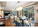 Open-concept design featuring a dining table and living area with a view of a fenced patio at 12051 E Lake Cir, Greenwood Village, CO 80111