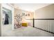 Upstairs loft area with a view into another room, black railings and neutral carpet at 12051 E Lake Cir, Greenwood Village, CO 80111