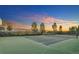 Well-maintained tennis court against a vibrant sunset; perfect for sports and recreation at 12051 E Lake Cir, Greenwood Village, CO 80111