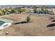 Wide aerial shot displaying a vast property with well-maintained fencing and multiple outbuildings and structures at 12901 2Nd St, Parker, CO 80134