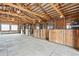 Spacious horse barn interior featuring multiple wooden stalls with metal bars at 12901 2Nd St, Parker, CO 80134