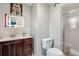 Well-lit bathroom features a sleek vanity with storage and a glass-enclosed shower, providing a modern and clean design at 12901 2Nd St, Parker, CO 80134