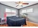 Stylish bedroom with hardwood floors, modern lighting, and a view to the outside at 12901 2Nd St, Parker, CO 80134