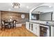 Elegant dining area featuring hardwood floors, wooden wall, and granite countertops at 12901 2Nd St, Parker, CO 80134