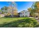 Spacious home with a well-manicured lawn and mature trees, set against a clear blue sky at 12901 2Nd St, Parker, CO 80134