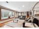 Bright living room with a large bay window, hardwood floors, and comfortable leather seating at 12901 2Nd St, Parker, CO 80134