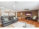 Inviting living room features a wooden accent wall, hardwood floors, and comfortable leather seating at 12901 2Nd St, Parker, CO 80134