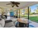 Inviting covered patio featuring comfortable seating, a ceiling fan, and a clear view of the backyard at 12901 2Nd St, Parker, CO 80134