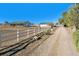 Picturesque property showcasing a charming white fence leading to a ranch style home and outbuildings at 12901 2Nd St, Parker, CO 80134