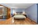 Comfortable bedroom with hardwood floors and access to bathroom at 9696 E Sand Lily Ln, Parker, CO 80134