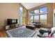 Spacious living room with hardwood floors and large windows at 9696 E Sand Lily Ln, Parker, CO 80134