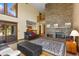 Living room with a large brick fireplace and hardwood floors at 9696 E Sand Lily Ln, Parker, CO 80134