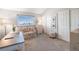 Serene bedroom with ample natural light, a cozy love seat, and closet space at 5252 W 68Th Ave, Arvada, CO 80003