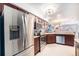 Modern kitchen with stainless steel appliances and breakfast bar area open to the dining and living areas at 5252 W 68Th Ave, Arvada, CO 80003