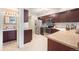 Spacious kitchen with updated appliances, ample counter space, and convenient access to a half-bathroom at 5252 W 68Th Ave, Arvada, CO 80003