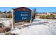 Britton Park sign surrounded by snowy landscape and residential neighborhood on a sunny day at 5252 W 68Th Ave, Arvada, CO 80003