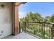 Balcony with brick trim and black railing overlooking the street at 1631 N Emerson St # 207, Denver, CO 80218