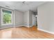 Bright bedroom with hardwood floors, ceiling fan, and a large window with bright natural light at 1631 N Emerson St # 207, Denver, CO 80218