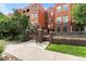 Brick exterior of a multi-story building with a landscaped walkway and fence at 1631 N Emerson St # 207, Denver, CO 80218