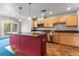 Modern kitchen with stainless steel appliances, a red kitchen island, and tile floors at 1631 N Emerson St # 207, Denver, CO 80218