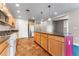 Bright kitchen with a large island, stainless steel appliances, tile floor, and wood cabinets at 1631 N Emerson St # 207, Denver, CO 80218