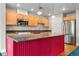 Open kitchen with stainless steel appliances, island and wood cabinets at 1631 N Emerson St # 207, Denver, CO 80218