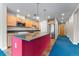 Modern kitchen featuring stainless steel appliances, tile floors, and a colorful red island at 1631 N Emerson St # 207, Denver, CO 80218