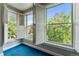 Corner of a living room showing three large windows with white shutters, and blue carpet at 1631 N Emerson St # 207, Denver, CO 80218