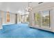 Large, bright living room with shutters, french doors and a modern chandelier at 1631 N Emerson St # 207, Denver, CO 80218