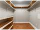 Spacious walk-in closet featuring wood floors, custom shelving, and ample storage space at 1631 N Emerson St # 207, Denver, CO 80218