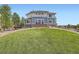 Home with a well-manicured lawn and brick accents, nestled in a peaceful neighborhood at 7485 S Jackson Gap Way, Aurora, CO 80016