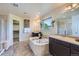 A luxurious bathroom with a soaking tub, double vanity, and a large walk-in closet at 7485 S Jackson Gap Way, Aurora, CO 80016