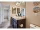 Bathroom featuring a double sink vanity, large mirror, and beach-themed decor at 7485 S Jackson Gap Way, Aurora, CO 80016