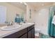Bright bathroom featuring a shower/tub combination and dual sink vanity at 7485 S Jackson Gap Way, Aurora, CO 80016
