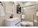 Stylish bathroom features a glass-enclosed shower and modern vanity with a decorative mirror at 7485 S Jackson Gap Way, Aurora, CO 80016