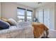 Bedroom featuring neutral carpeting, a cozy bed, and abundant natural light at 7485 S Jackson Gap Way, Aurora, CO 80016