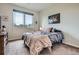 Cozy bedroom with a soft bed, plush blanket, and a large window overlooking the neighborhood at 7485 S Jackson Gap Way, Aurora, CO 80016
