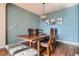 Stylish dining room with elegant furnishings, including a wooden table, comfortable chairs, and modern lighting at 7485 S Jackson Gap Way, Aurora, CO 80016